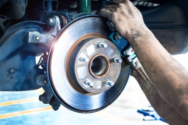 Brake disc inspection representing a back-to-school safety campaign for automotive workshops.
